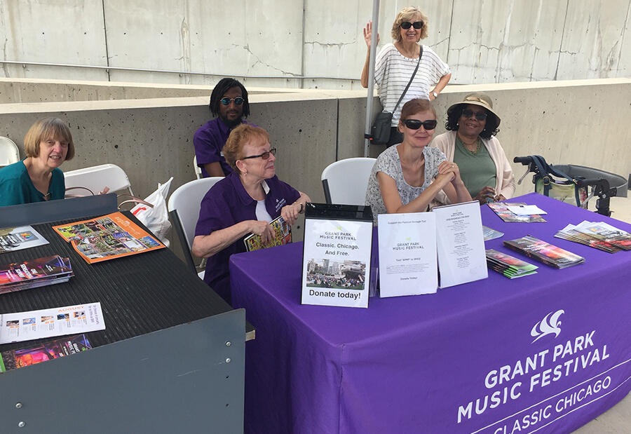 Festival volunteers staff the welcome tent during a Grant Park Orchestra rehearsal