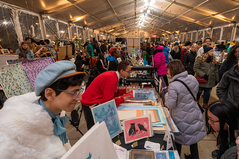 Shoppers peruse works by local artists at the Art Market in the Chase Promenade North Tent in Millennium Park