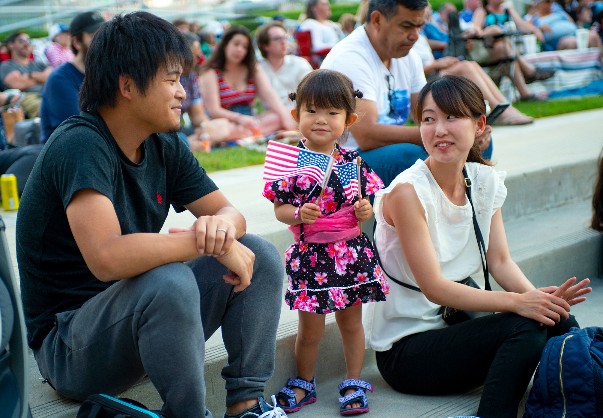 A family seated at the edge of the Great Lawn