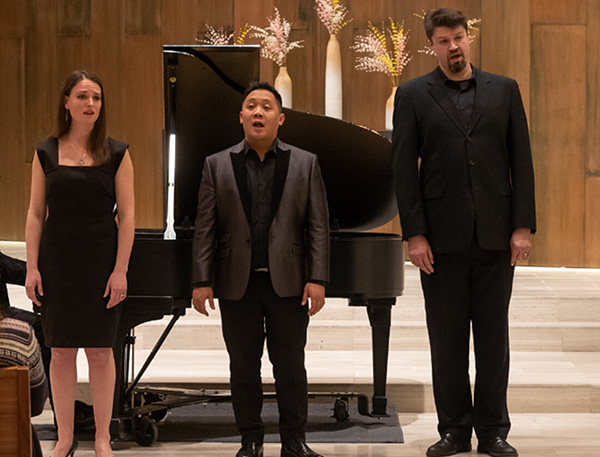 Grant Park Chorus members Sarah Van Der Ploeg, Ace Gangoso, and David Govertsen