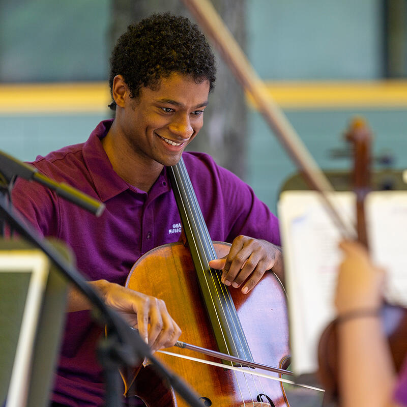 Cellist Cole Randolph performs in Chicago Women's Park with the Festival String Fellows