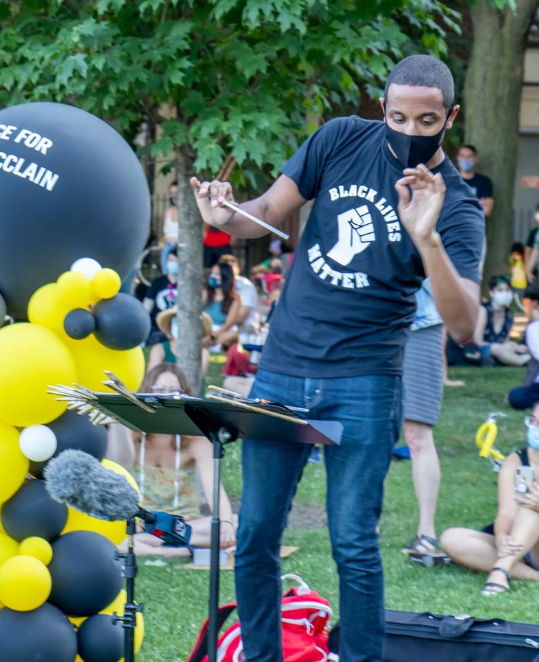 Kyle Dickson on the podium at the Elijah McClain vigil in Chicago's Oz Park