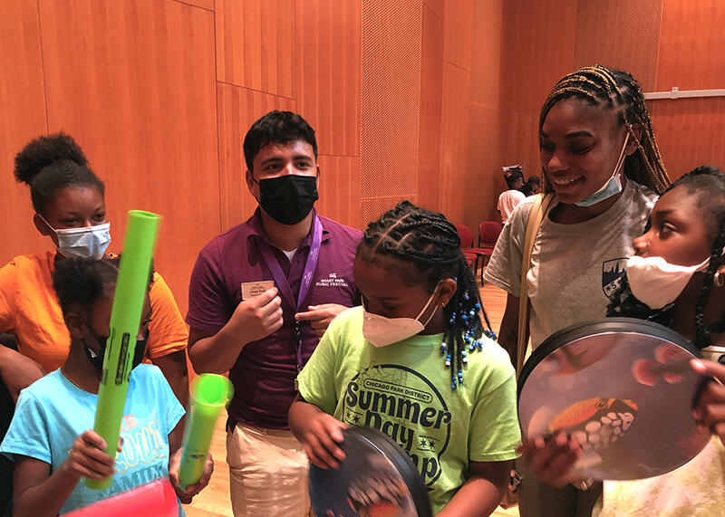 Teaching artist Chad Polk organizes an impromptu percussion ensemble with the Classical Campers